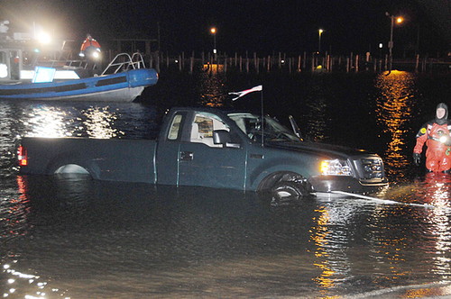 Emergency crews haul a pickup truck out of the water near Shore Front Park and Smith Street after a driver slammed through a dock and landed in Patchogue Bay. (Photo by James Carbone / December 21, 2008)